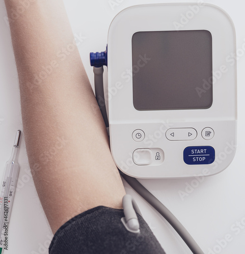 Man measures blood pressure. arterial hypotension. hand and tonometer close up. Healthcare and medical concept