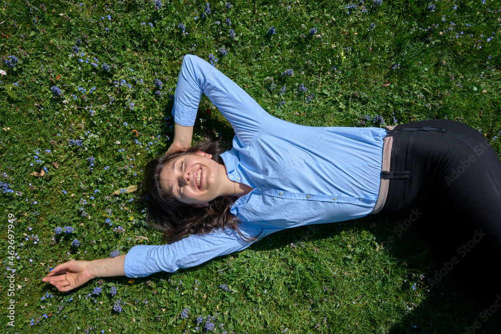 Portrait of happy young woman relaxing on a meadow Portrait of happy young woman relaxing on a meadow