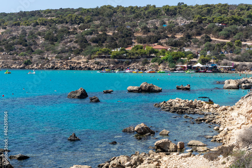 Crystal clear blue water of Mediterranean sea and yellow rocks in on Konnos beach near Protaras, Cyprus