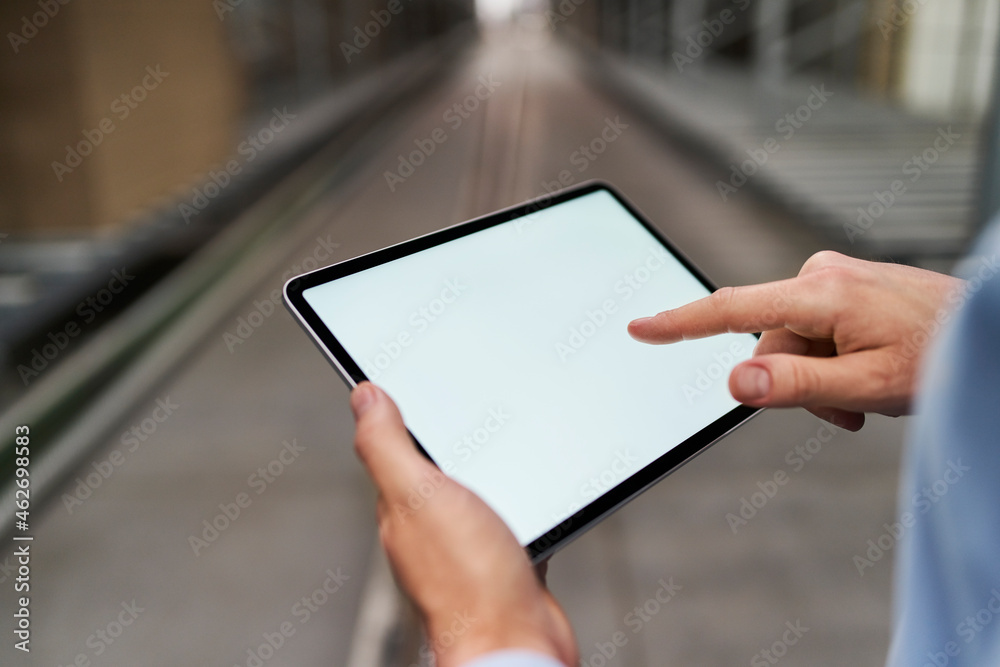 Close-up of businessman using tablet in factory Close-up of businessman using tablet in factory