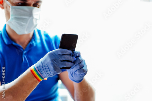 Doctor with face mask, using smartphone photo