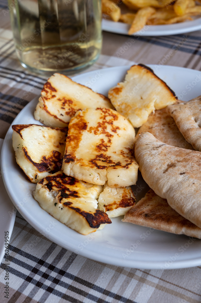 Traditional roasted or grilled halloumi cheese from Cyprus served hot with flat bread Traditional roasted or grilled halloumi cheese from Cyprus served hot with flat bread