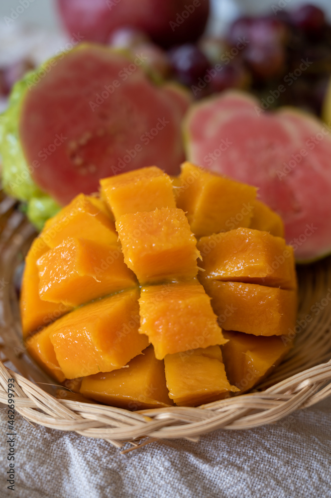 Exotic fruits of Cyprus, fresh yellow juicy mango, ripe pink guava, bananas and sweet table grapes Exotic fruits of Cyprus, fresh yellow juicy mango, ripe pink guava, bananas and sweet table grapes