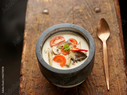 Asian Tom Kha Gai soup in bowl photo