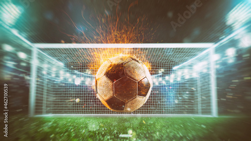 Close up of a fiery soccer ball kicked with power at the stadium scoring a goal © alphaspirit