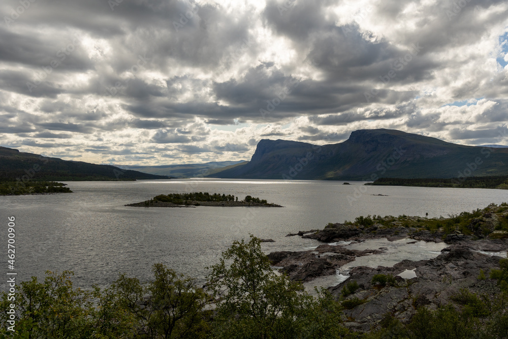 A Swedish Lakeview in the Stora Sjöfallet National Park on a cloudy sky. The view is of the luleälven lake in the park. A Swedish Lakeview in the Stora Sjöfallet National Park on a cloudy sky. The view is of the luleälven lake in the park.