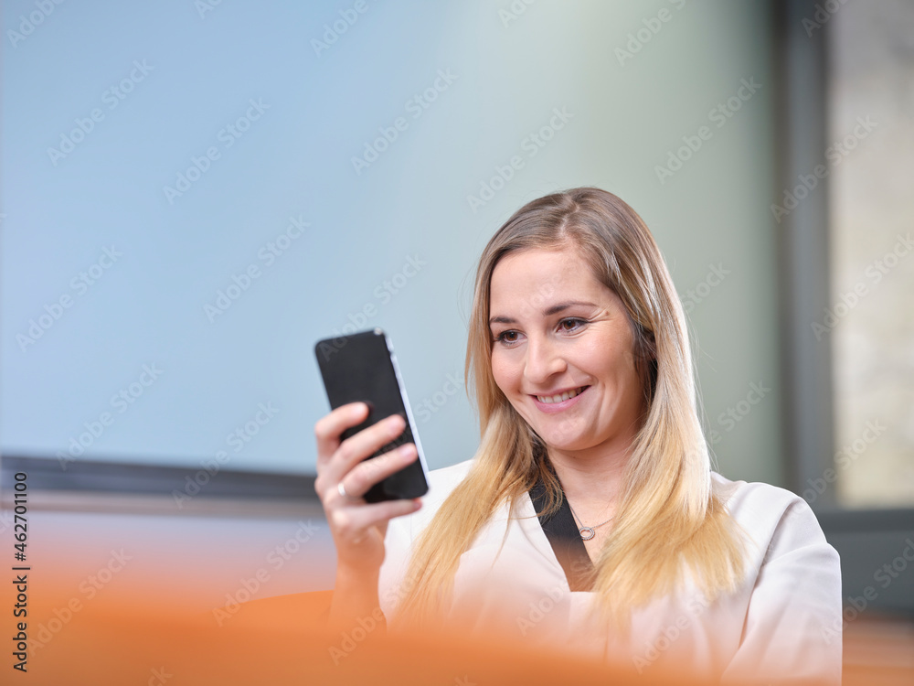 Portrait of smiling businesswoman using cell phone Portrait of smiling businesswoman using cell phone