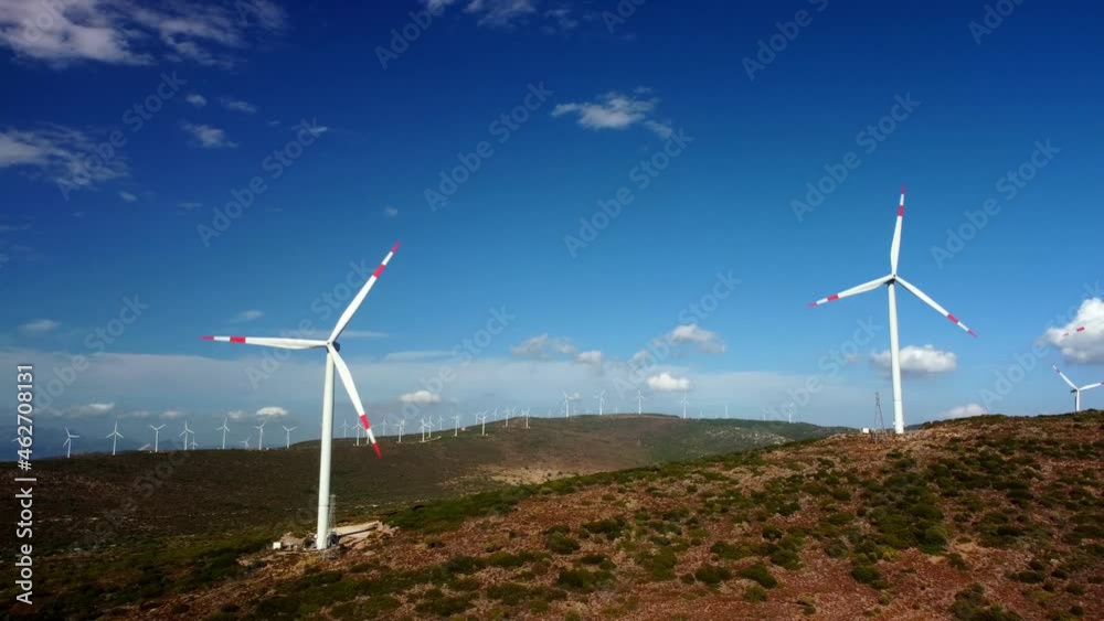 Aerial view over the farm landscape and wind turbines generating clean renewable energy. Renewable energy production for the green ecological world. High quality 4k footage Aerial view over the farm landscape and wind turbines generating clean renewable energy. Renewable energy production for the green ecological world. High quality 4k footage
