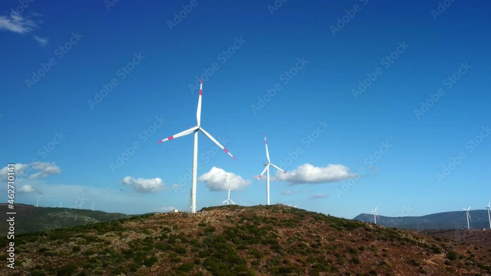 Aerial view over the farm landscape and wind turbines generating clean renewable energy. Renewable energy production for the green ecological world. High quality 4k footage Aerial view over the farm landscape and wind turbines generating clean renewable energy. Renewable energy production for the green ecological world. High quality 4k footage