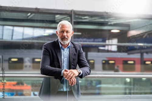 Portrait of mature businessman at the station platform photo
