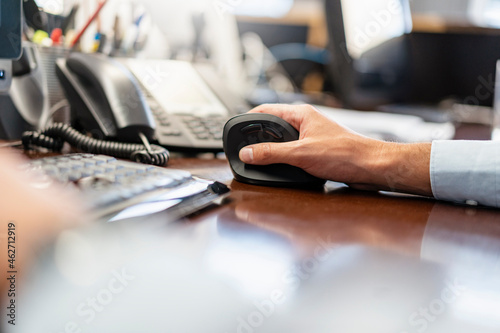 Close-up of businessman using ergonomic mouse in office