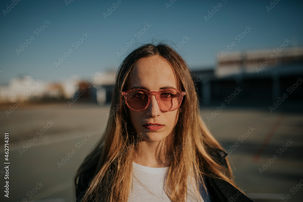 Portrait of young woman wearing sunglasses outdoors Portrait of young woman wearing sunglasses outdoors