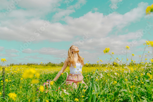 Young woman in a flower meadow in spring photo