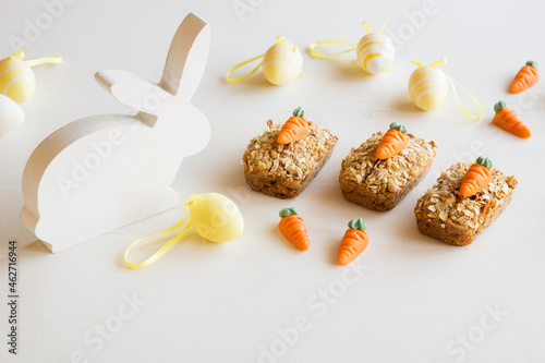 Three mini carrot cakes with marzipan carrots and Easter decoration