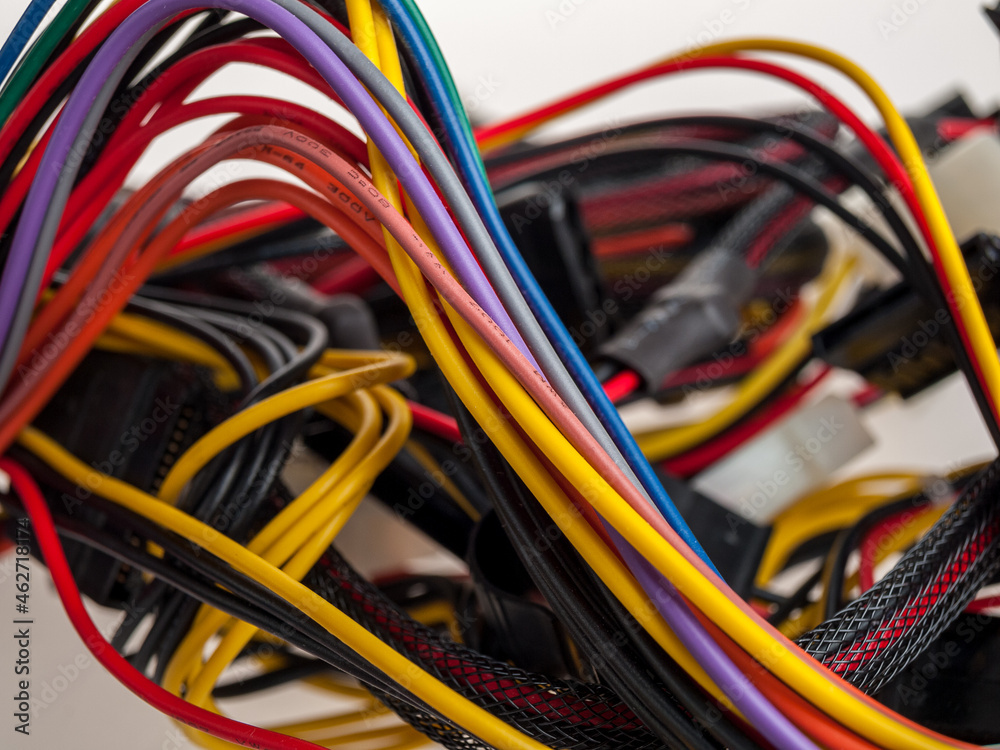 electric wires in a braid close-up and on a background, multi-colored wires for connecting electrical appliances and equipment electric wires in a braid close-up and on a background, multi-colored wires for connecting electrical appliances and equipment