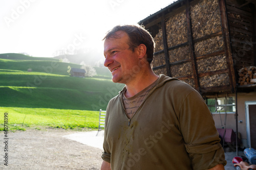 Farmer milking a cow in stable