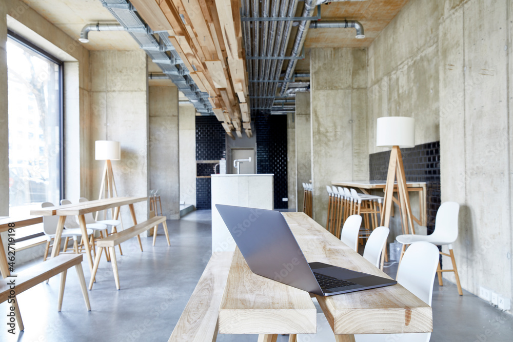 Laptop on wooden boards in modern office Laptop on wooden boards in modern office