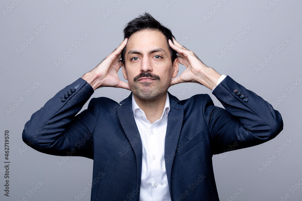 Portrait of businessman with hands on head Portrait of businessman with hands on head
