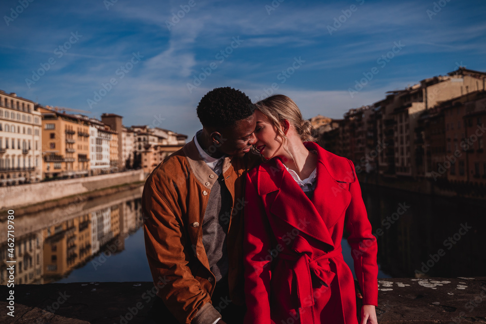 Affectionate young couple kissing on a bridge in the city of Florence, Italy Affectionate young couple kissing on a bridge in the city of Florence, Italy