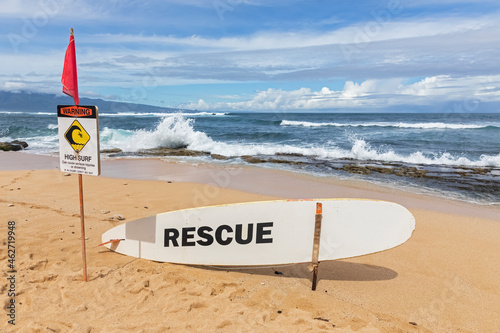 Rescue surfboard, red flag and warning sign at Ho'okipa Beach Park, Hawaii, USA photo