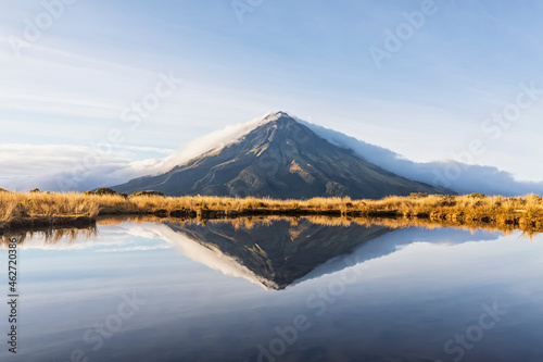 New Zealand, MountÔøΩTaranakiÔøΩvolcano reflecting in shiny lake at dawn photo