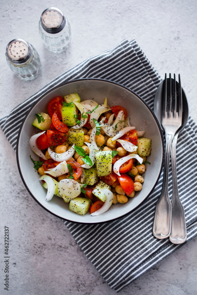 Salad with cucumbers, chickpeas, onion, cherry tomatoes, basil, chia seed Salad with cucumbers, chickpeas, onion, cherry tomatoes, basil, chia seed