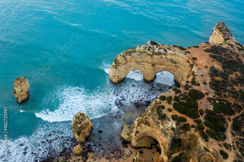 Portugal, Algarve, Lagoa, Drone view of turquoise waters of Atlantic Ocean and coastal rock arch photo