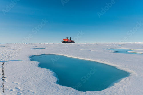 Aerial view of melting ice on North Pole with ice-breaker 50 Years of Victory in background photo