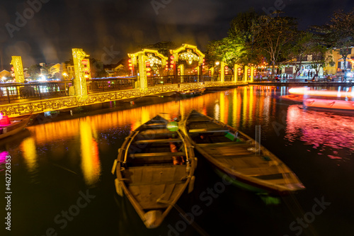 Vietnam,ÔøΩHoiÔøΩAn, Boats on river in old town illuminated at night