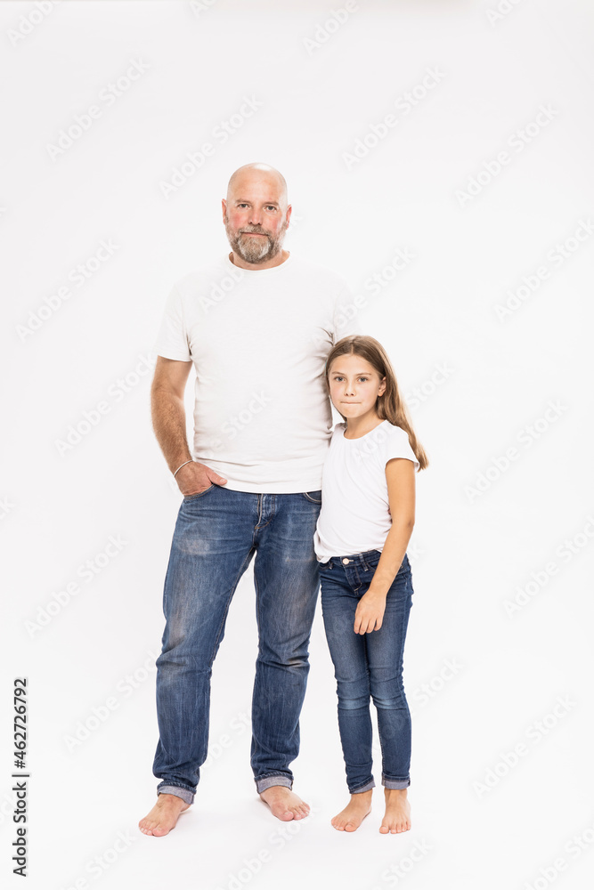 Bald father with daughter standing against white background Bald father with daughter standing against white background