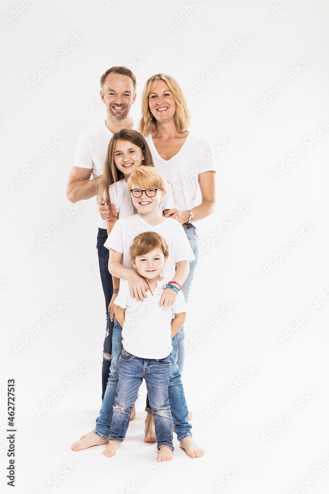Happy family with children standing in row against white background Happy family with children standing in row against white background