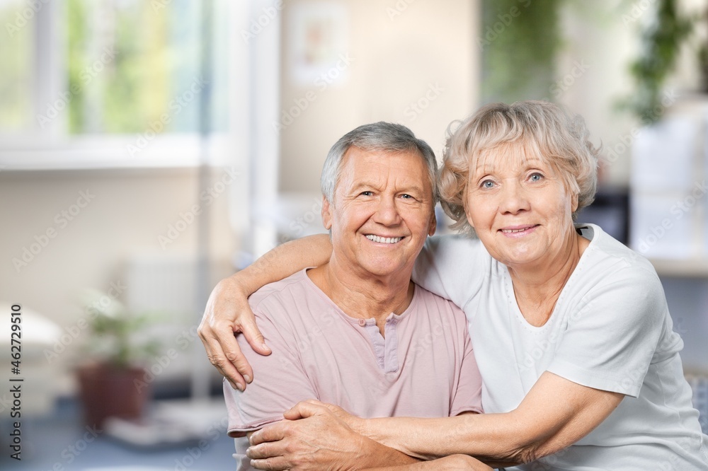 Happy older mature classy couple hugging, thinking of good future.