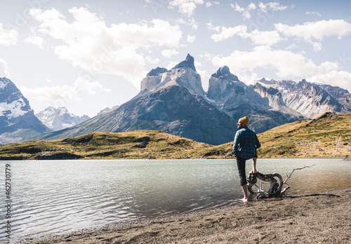 Hiker in mountainscape at lakeside in Torres del Paine National Park, Patagonia, Chile photo