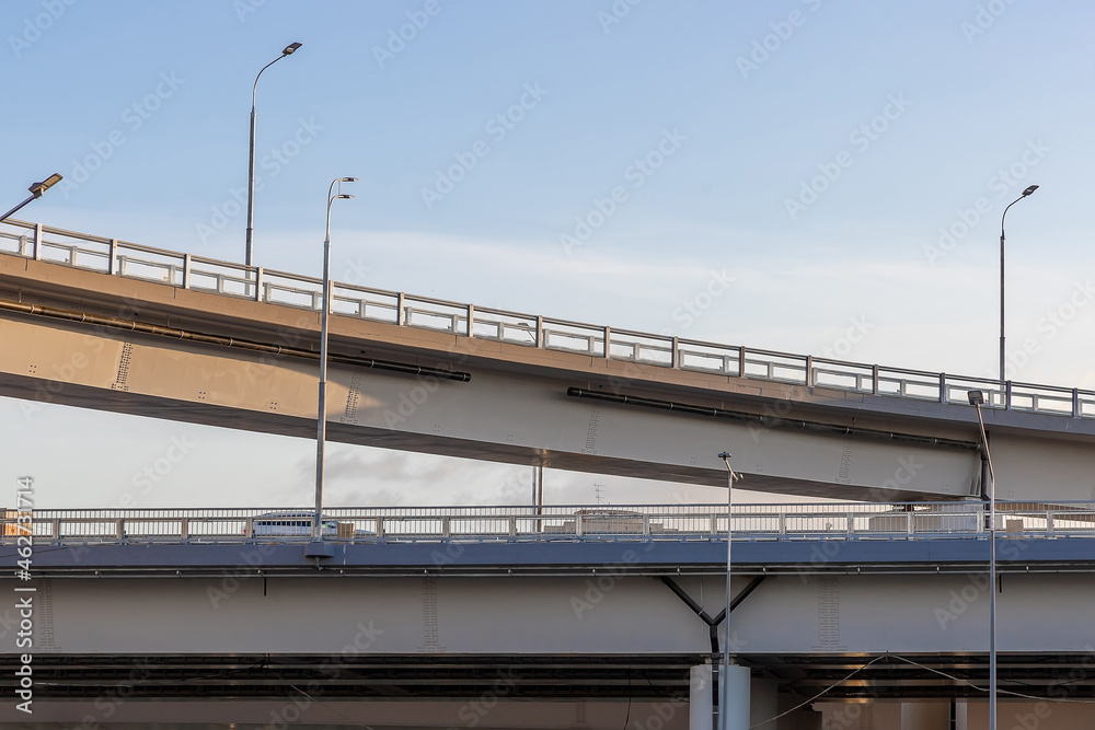 Fragment of a multilevel road junction, bottom view. Modern road construction of roads and bridges. Road infrastructure