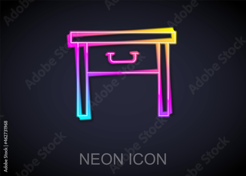 Glowing neon line Furniture nightstand icon isolated on black background. Vector