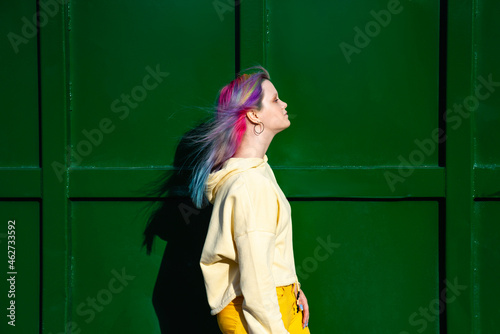 Wallpaper Mural Portrait of young woman with dyed hair in front of green container Torontodigital.ca