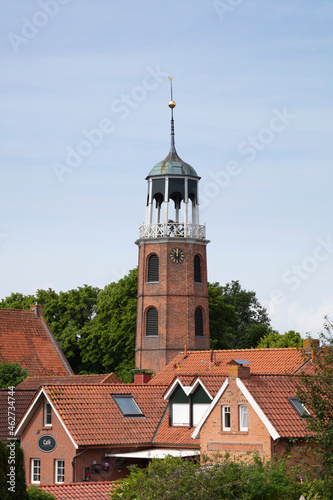 Germany, Lower Saxony, Ditzum, Bell tower surrounded by town houses photo