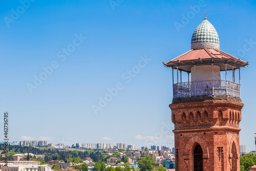 Minaret of Jumah Mosque against clear blue sky during sunny day, Tbilisi, Georgia photo