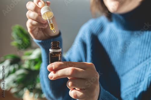 Cbd alternative therapy - Woman holding bottle of cannabis oil for anxiety treatment