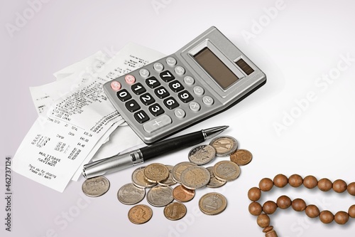 Concept of islamic finance. Coins and praying beads. Zakat, islamic banking