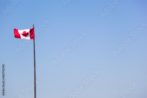 Canadian flag against blue sky