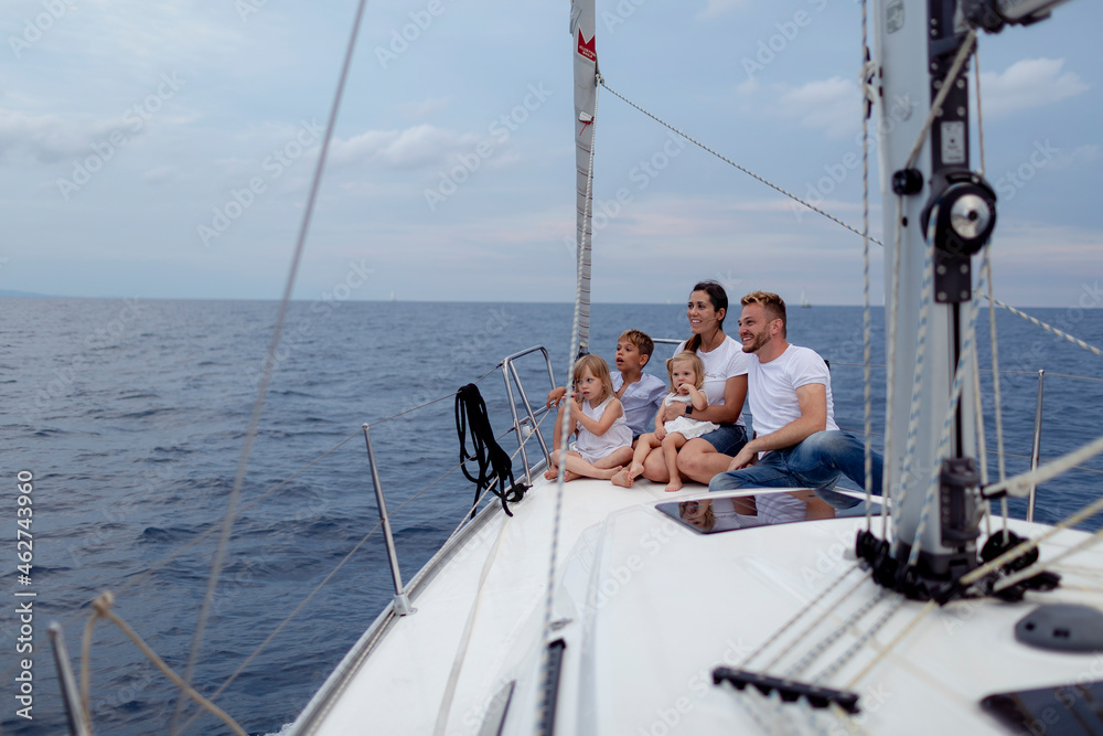 Family sitting on deck during sailing trip Family sitting on deck during sailing trip