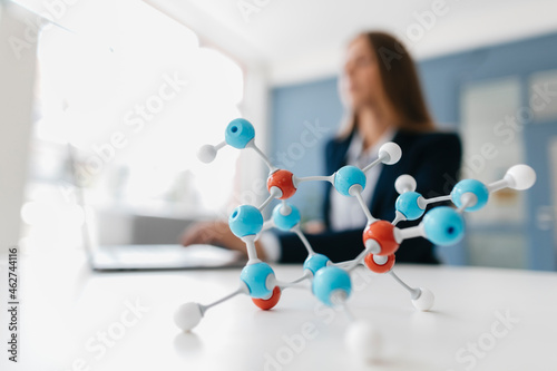 Female scientist studying molecule model photo