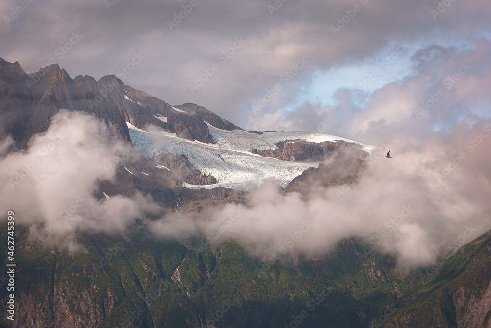 View of mountain peak surrounded by clouds in Alaska, USA.