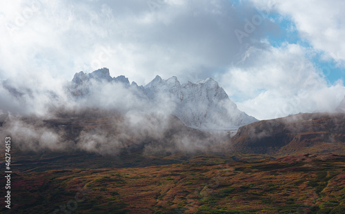 View of mountain peak surrounded by clouds in Alaska  USA.