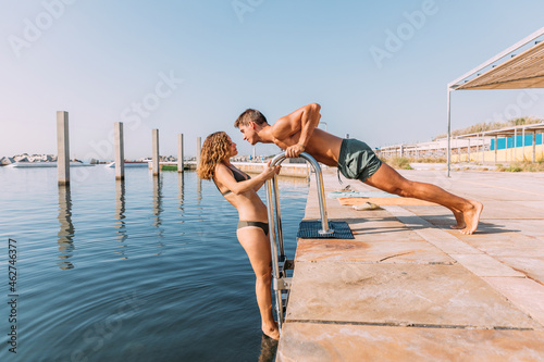 Young couple on a pier at the sea photo