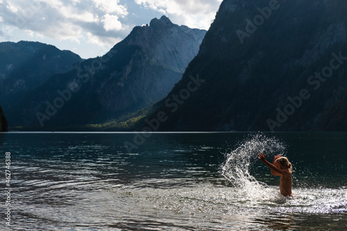 Germany, Upper Bavaria, Girl bathing in Lake Koenigssee photo