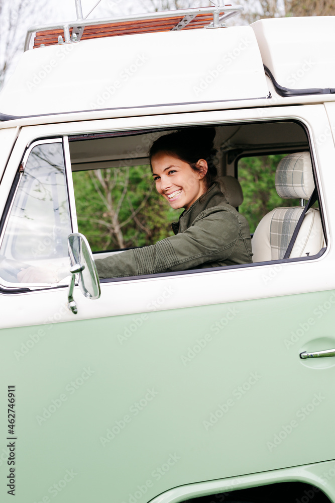 Young woman sitting in camperm looking out of window Young woman sitting in camperm looking out of window