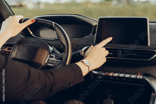 Young woman using navigation device in car