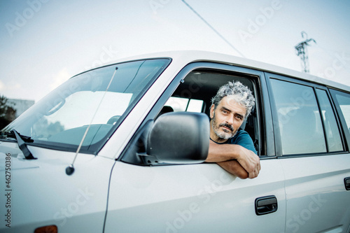 Mature man sitting in his off-road vehicle
